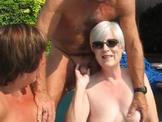 Sheila jerks a cock by the pool